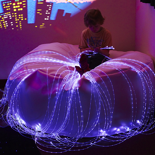 child playing with fibre optics